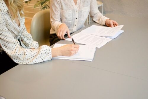 two people looking at paperwork