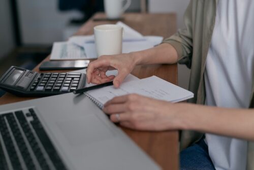 person at computer looking at document