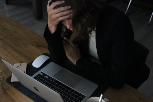 stressed woman sitting at computer