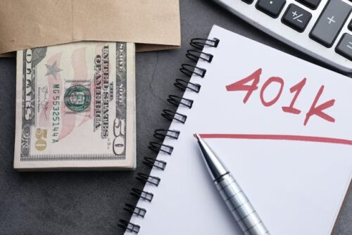 notebook with pen, 401(k), and money