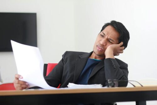 stressed man looking at paper
